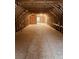 Spacious unfinished attic ready for customization, featuring exposed rafters and plywood subflooring at 2460 Bama Rd, Cottageville, SC 29435