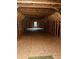 Unfinished attic space with exposed wooden beams and ample natural light from a centered window at 2460 Bama Rd, Cottageville, SC 29435