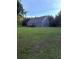 Spacious backyard featuring a well-maintained lawn and a blue one-story house at 2460 Bama Rd, Cottageville, SC 29435