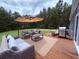 Relaxing outdoor deck area with comfortable seating, a grill, and a peaceful view at 2460 Bama Rd, Cottageville, SC 29435