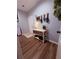 View of a welcoming entryway with wood-look floors, storage bench, and light blue walls at 2460 Bama Rd, Cottageville, SC 29435