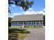 Charming one-story home with blue siding, black shutters, and a gravel driveway at 2460 Bama Rd, Cottageville, SC 29435