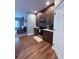 Close up of kitchen cabinets and appliances with wooden floors and white door at 2460 Bama Rd, Cottageville, SC 29435