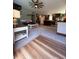 Cozy living room with plush carpet, ceiling fan, and view of the kitchen at 2460 Bama Rd, Cottageville, SC 29435