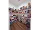 Pantry with wood floor and metal shelves filled with food items and containers at 2460 Bama Rd, Cottageville, SC 29435