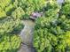 Aerial view of the home surrounded by lush greenery, showcasing its private setting and natural beauty at 24678 Augusta Hwy, Cottageville, SC 29435
