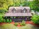 Aerial perspective of a cabin with a covered porch surrounded by landscaped lawn and greenery at 24678 Augusta Hwy, Cottageville, SC 29435