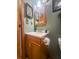 Cozy bathroom featuring a wood vanity and framed mirror at 24678 Augusta Hwy, Cottageville, SC 29435