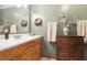 Bathroom featuring a wood vanity, linoleum floors, and tastefully decorated walls at 24678 Augusta Hwy, Cottageville, SC 29435