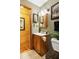 Cozy bathroom featuring a wooden vanity, charming fixtures, and rustic decorations for a warm atmosphere at 24678 Augusta Hwy, Cottageville, SC 29435