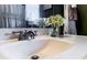 Close up of bathroom sink with nickel faucet, decorative flowers and soft towels at 24678 Augusta Hwy, Cottageville, SC 29435
