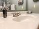 Close-up of a white bathroom sink with a chrome faucet and elegant soap dispenser, highlighting the clean and modern design at 24678 Augusta Hwy, Cottageville, SC 29435