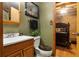 Rustic bathroom with wooden cabinets, log walls, and decorative accents creating a cozy, cabin-like ambiance at 24678 Augusta Hwy, Cottageville, SC 29435