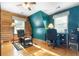 Bedroom with hardwood floors, wooden walls, and a vintage ceiling fan at 24678 Augusta Hwy, Cottageville, SC 29435