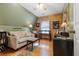 Bedroom featuring hardwood floors, wooden walls, and a vintage ceiling fan at 24678 Augusta Hwy, Cottageville, SC 29435