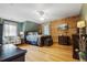 Bedroom featuring hardwood floors, wooden walls, and a vintage ceiling fan at 24678 Augusta Hwy, Cottageville, SC 29435