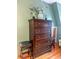 Bedroom with a large, dark-wood dresser with drawer pulls, featuring stylish decor and complementary seating at 24678 Augusta Hwy, Cottageville, SC 29435