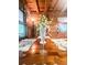 Dining room with wooden table featuring a floral arrangement and views of the outdoors at 24678 Augusta Hwy, Cottageville, SC 29435
