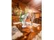 Dining room with wood table, decorative flower arrangement, and rustic cabin decor at 24678 Augusta Hwy, Cottageville, SC 29435
