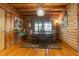 Welcoming dining area featuring log walls, hardwood floors, a round table, and rustic decor at 24678 Augusta Hwy, Cottageville, SC 29435