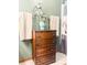 Bathroom with a dark wood dresser topped with vase and flowers. Adjacent to two neatly folded towels at 24678 Augusta Hwy, Cottageville, SC 29435