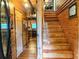 Inviting entryway with wooden stairs and views into the kitchen and hallway at 24678 Augusta Hwy, Cottageville, SC 29435
