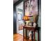 Charming entryway with a decorative table, horse painting, and view into the bathroom at 24678 Augusta Hwy, Cottageville, SC 29435