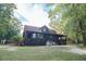 Charming log cabin with a welcoming exterior and spacious yard at 24678 Augusta Hwy, Cottageville, SC 29435