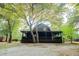 Beautifully maintained log cabin exterior with a spacious yard surrounded by mature trees at 24678 Augusta Hwy, Cottageville, SC 29435