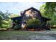 Exterior of a log cabin-style home with mature trees at 24678 Augusta Hwy, Cottageville, SC 29435