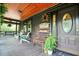 Inviting front porch of log cabin featuring seating, welcome sign, and wood ceiling at 24678 Augusta Hwy, Cottageville, SC 29435