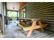 Rustic log cabin porch with a picnic table, perfect for outdoor dining and relaxation at 24678 Augusta Hwy, Cottageville, SC 29435