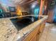 Kitchen island featuring a smooth, black cooktop and elegant granite countertops at 24678 Augusta Hwy, Cottageville, SC 29435