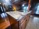 Kitchen island featuring smooth cooktop and granite countertops in a rustic wood kitchen at 24678 Augusta Hwy, Cottageville, SC 29435