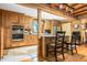 Rustic wood kitchen showcasing stainless steel appliances, tile floors, and granite countertops at 24678 Augusta Hwy, Cottageville, SC 29435