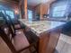 Kitchen island featuring a smooth, black cooktop, elegant granite, and bar stool seating at 24678 Augusta Hwy, Cottageville, SC 29435