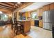 Bright kitchen featuring wooden cabinets, granite countertops, stainless steel appliances, and tiled floors at 24678 Augusta Hwy, Cottageville, SC 29435