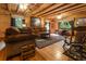 Spacious living room with wood beam ceilings, and a rustic rug creating a cozy ambiance at 24678 Augusta Hwy, Cottageville, SC 29435