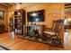 Living room features a wood-burning fireplace, a rocking chair, and a mounted television at 24678 Augusta Hwy, Cottageville, SC 29435