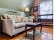 Comfortable living room with a plush couch, accent pillows, and log cabin style walls at 24678 Augusta Hwy, Cottageville, SC 29435