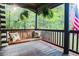 Enjoy the outdoors from the porch swing with decorative pillows and hanging ferns at 24678 Augusta Hwy, Cottageville, SC 29435