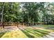 Picturesque property featuring expansive green lawn, tree coverage, and rustic fence at 24678 Augusta Hwy, Cottageville, SC 29435