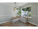 Light-filled dining area with a table, bench, and large window at 252 Howle Ave # C3, Charleston, SC 29412
