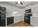 Updated kitchen featuring white cabinets, black appliances, and stylish backsplash at 252 Howle Ave # C3, Charleston, SC 29412