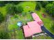 Aerial view of a home with a red roof, green lawn, a pool, and a wooden fence at 274 Harvest Rd, Moncks Corner, SC 29461