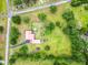 Aerial view of a red-roofed home, with green grass, trees, and a long driveway at 274 Harvest Rd, Moncks Corner, SC 29461