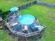 Aerial view of a wooden deck with an above ground pool, lounge chairs and umbrella at 274 Harvest Rd, Moncks Corner, SC 29461