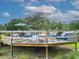 Wooden back deck with an above ground pool and lounge chairs, surrounded by a wooden fence at 274 Harvest Rd, Moncks Corner, SC 29461