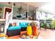A well-furnished and colorful back porch providing a comfortable and stylish outdoor living space at 274 Harvest Rd, Moncks Corner, SC 29461