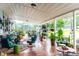 Spacious and inviting back porch featuring ample seating, lush greenery, and a serene outdoor atmosphere at 274 Harvest Rd, Moncks Corner, SC 29461